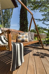 Wooden terrace with a garden swing
