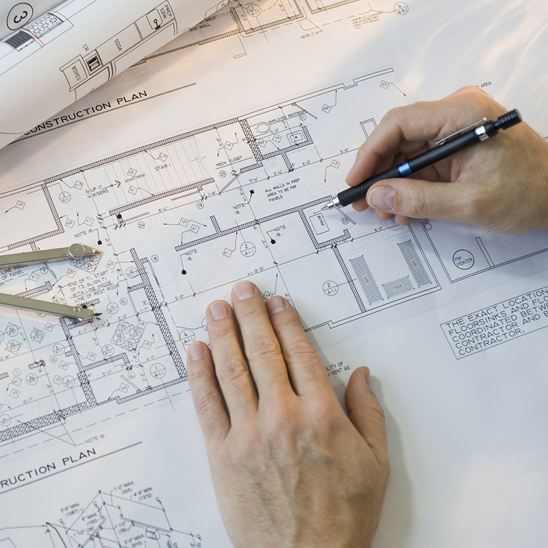 Architect drawing blueprints