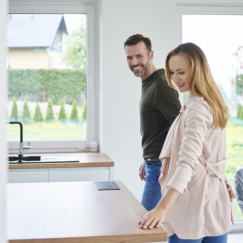 Couple examining kitchen in new flat