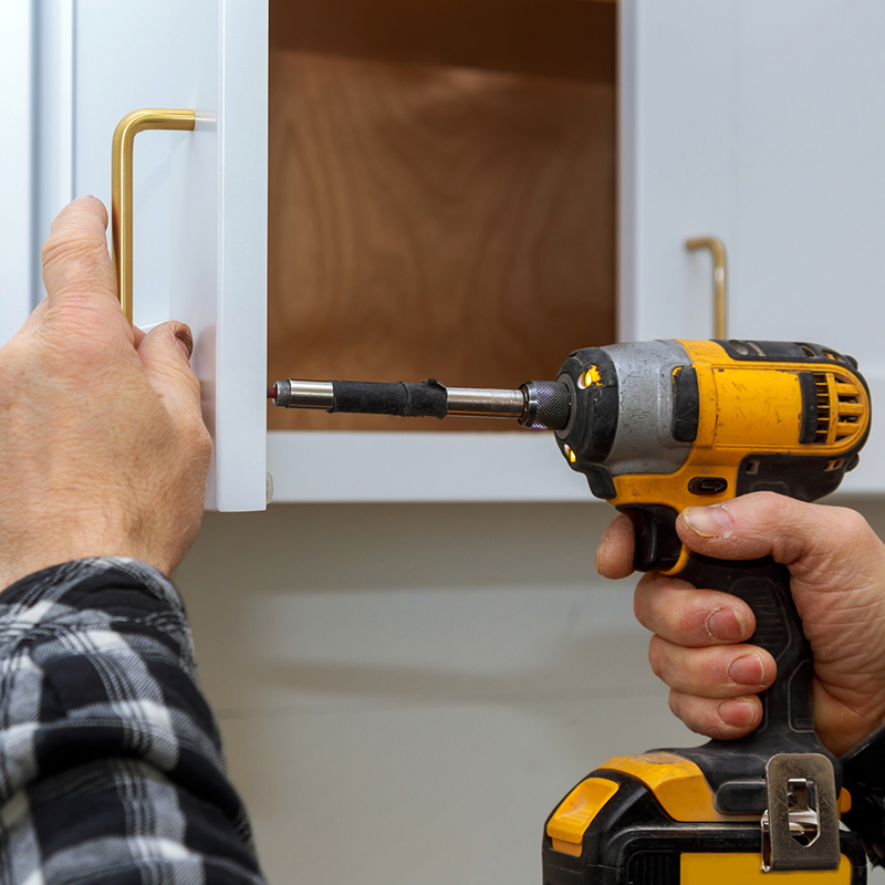 The installing a furniture handle process of assembling cabinet