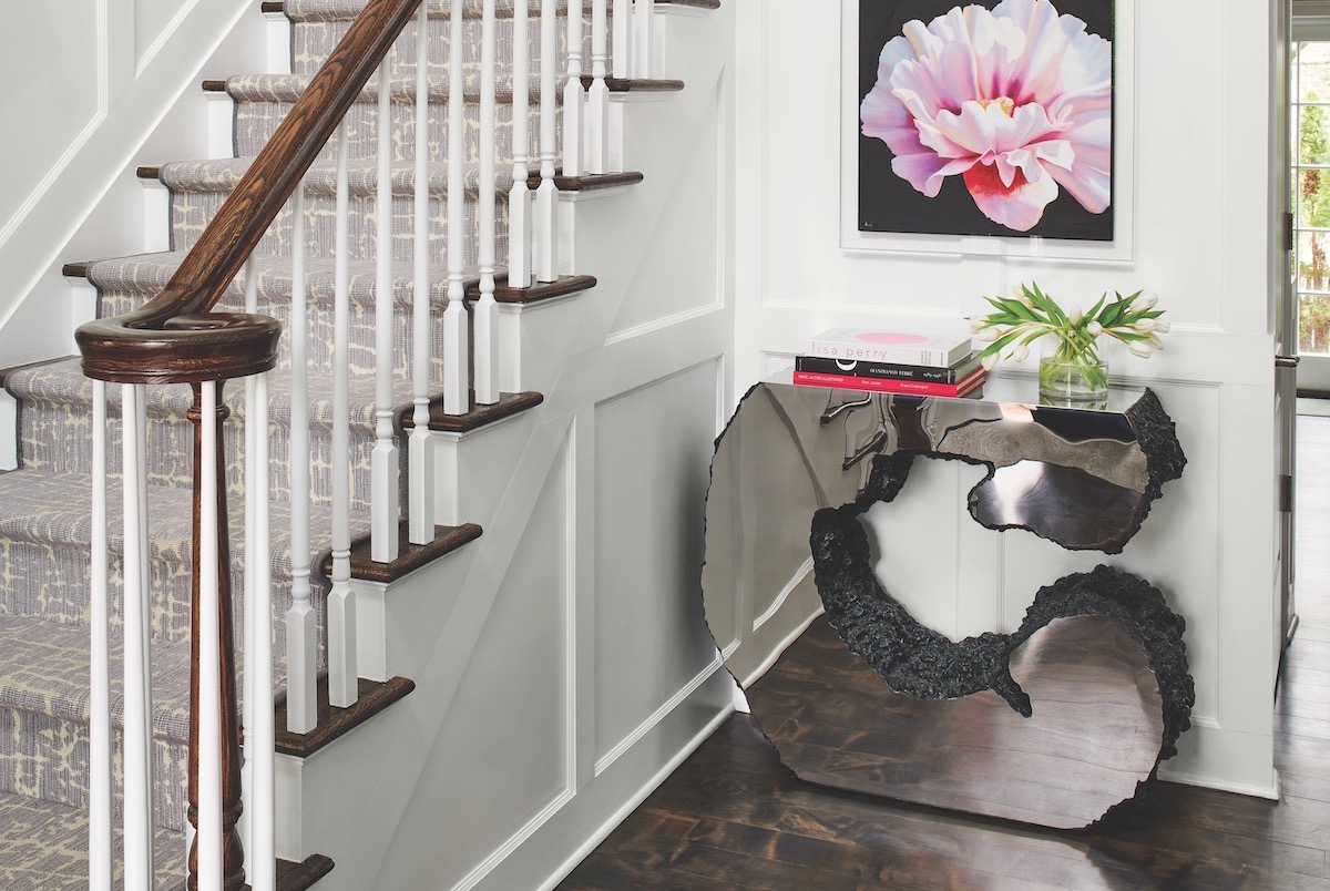 Refinished floors, eye-candy art and a striking console make for a grand foyer entrance