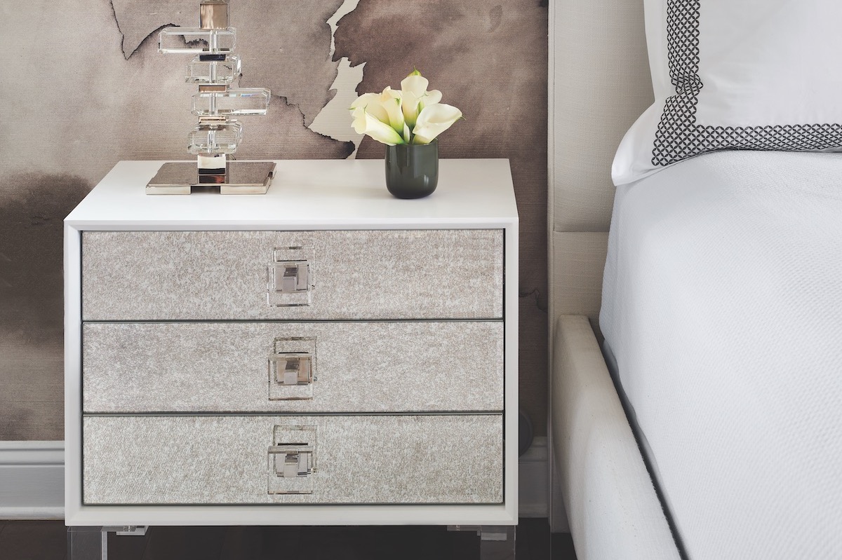 The ModShop nightstands have mirrored fronts and acrylic trim; the lamp is from Visual Comfort.