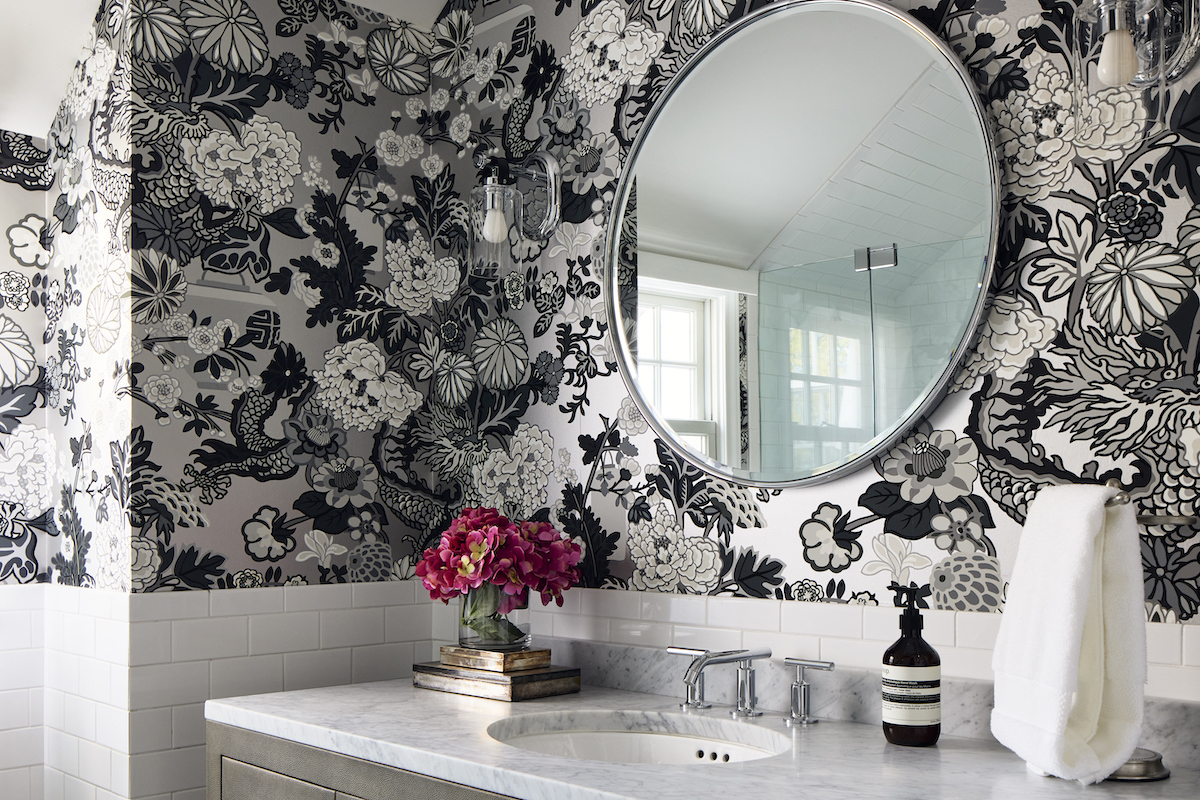 The Schumacher wallpaper in one of the bathrooms evokes thoughts of exotic travels. Other worldly touches: The Italian Carrara marble sink countertop and vintage silver humidors from Buenos Aires. 