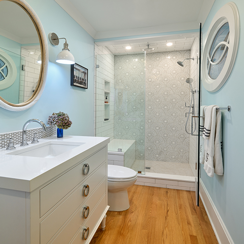 This guest bathroom, also boasting a view, is a study in circular patterns from the shower mosaic to the mid-century mirror.