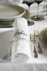 A tiny personal touch goes a long way—guests’ names are printed on strips of clear acetate and tied around napkins with a silver cord.