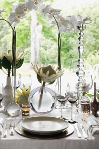 Silver-bordered chargers purchased in Marrakesh and white glazed pottery plates continue the Moroccan theme on the tabletop.