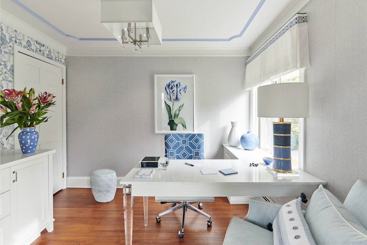 “The attention to detail in this sumptuous home office is rewarding for me,” says designer Pamela Cooper. “I love the color scheme, blue painted molding detail on the ceiling, lighting with crystals and the comfortable chair for [the homeowner’s] relaxing moments.” Cooper’s favorite element: the Thibaut Sakura blue-and-white wallpaper, which served as the inspiration for the entire space.