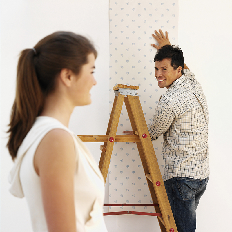 Young couple handing wallpaper