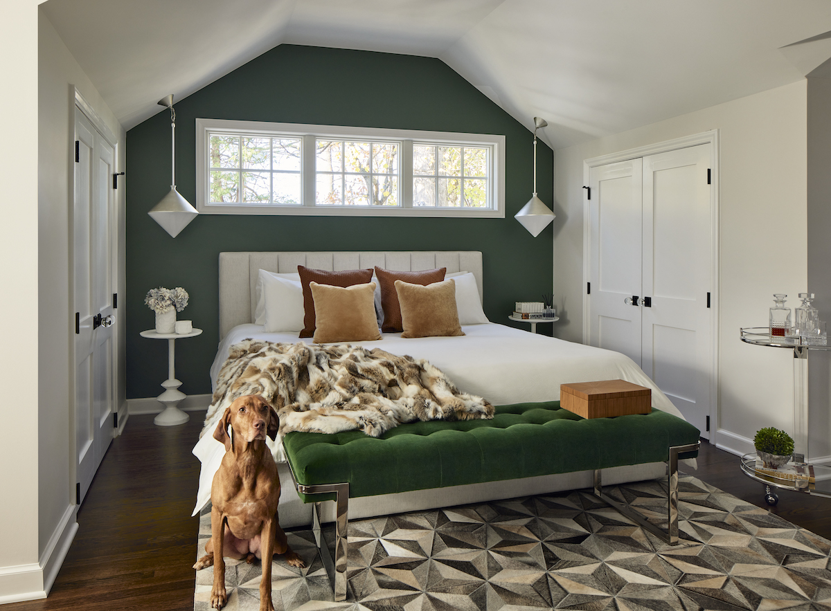 Affectionately called the FROG (finished room over garage), the upstairs suite leaps with color, thanks to the green accent wall and upholstered bench.