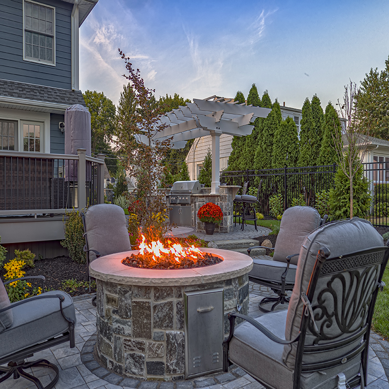 The firepit is one of three entertaining “zones” in this renovated backyard; it allows the homeowners to take advantage of their outside space all year round.