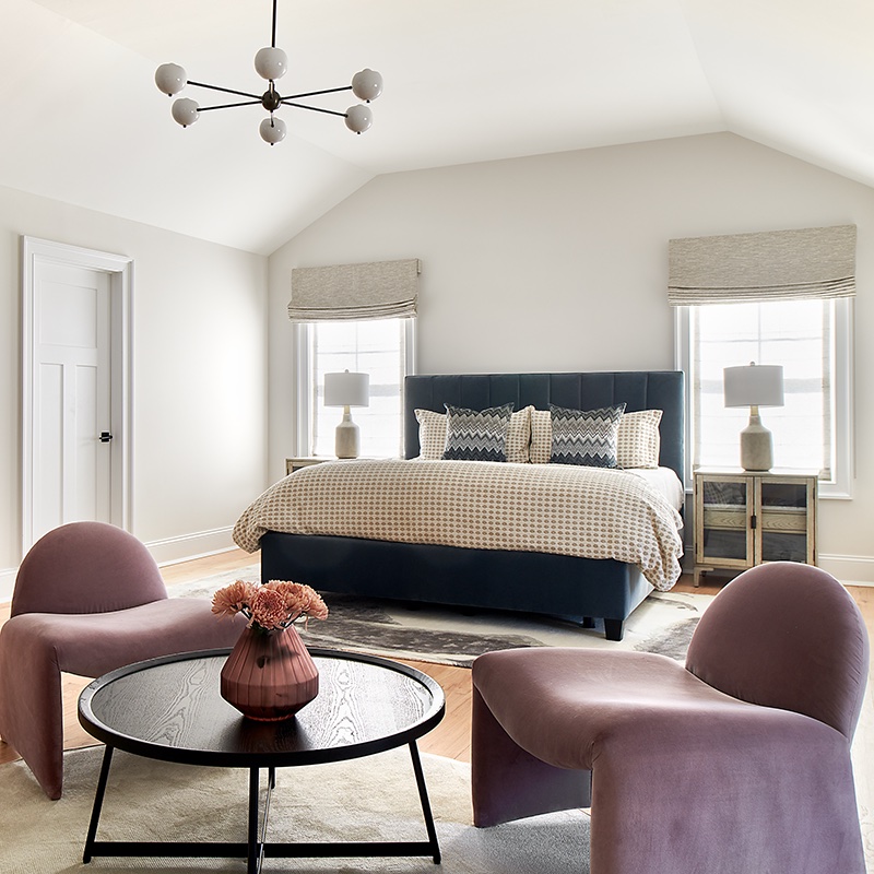 To create a sense of intimacy in the expansive primary bedroom, the design team created distinct zones with furniture.